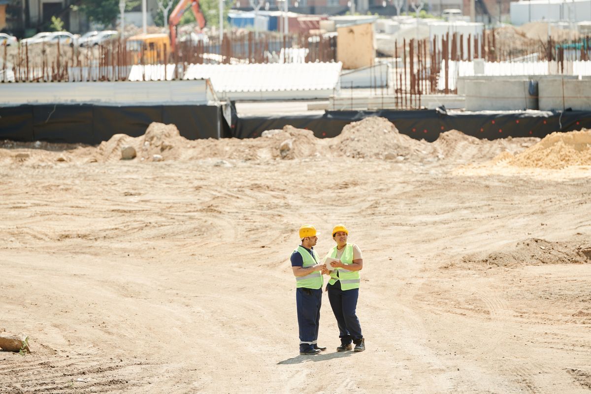 Construction team reviewing an active site excavation